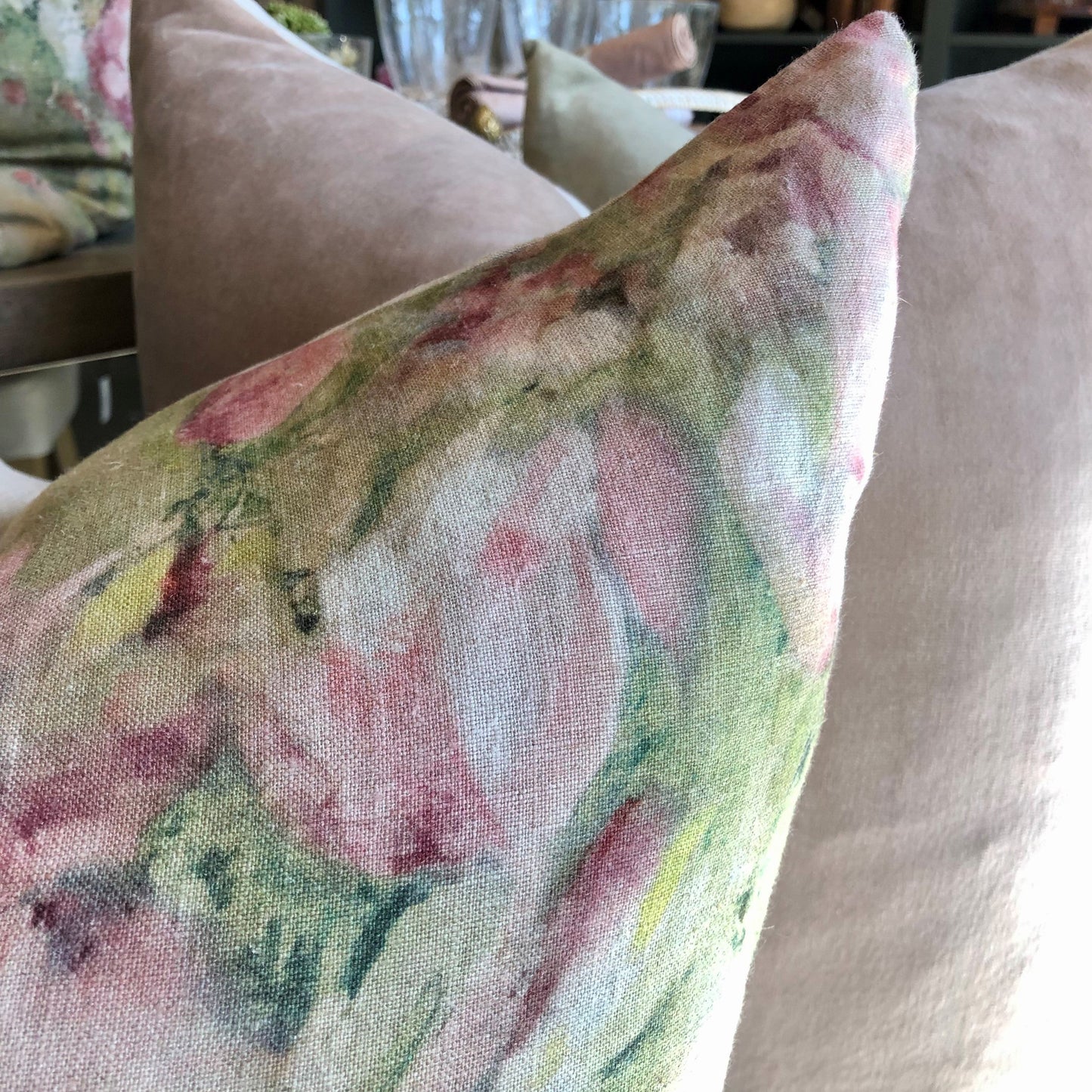The Magnolia Floral Limone Linen Cushion celebrates the beauty of Spring with its vibrant pink magnolia flowers on a 100% linen background. An ideal addition to any home, this cushion is perfect for bringing life and style to any room. Comes complete with a luxurious feather filled insert. Close up corner.
