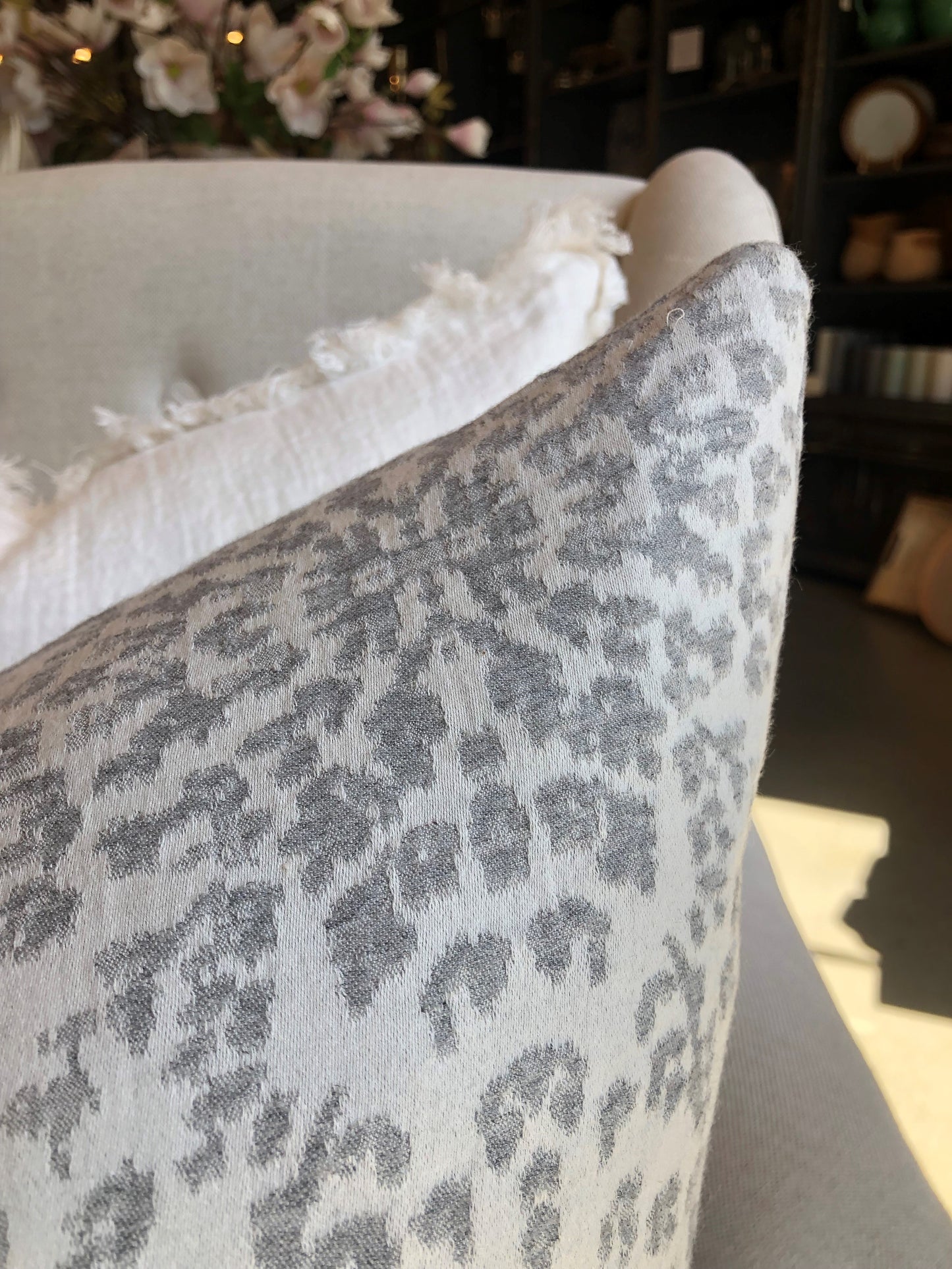 This Aspen Silver White Cotton & Cashmere Reversible Cushion is luxuriously soft, with exclusive plump feather insert for added comfort. Featuring a reversible design with snowflakes gracefully falling on both sides, choose from a crisp white or cool silver grey to accessorise your space. Corner close up.