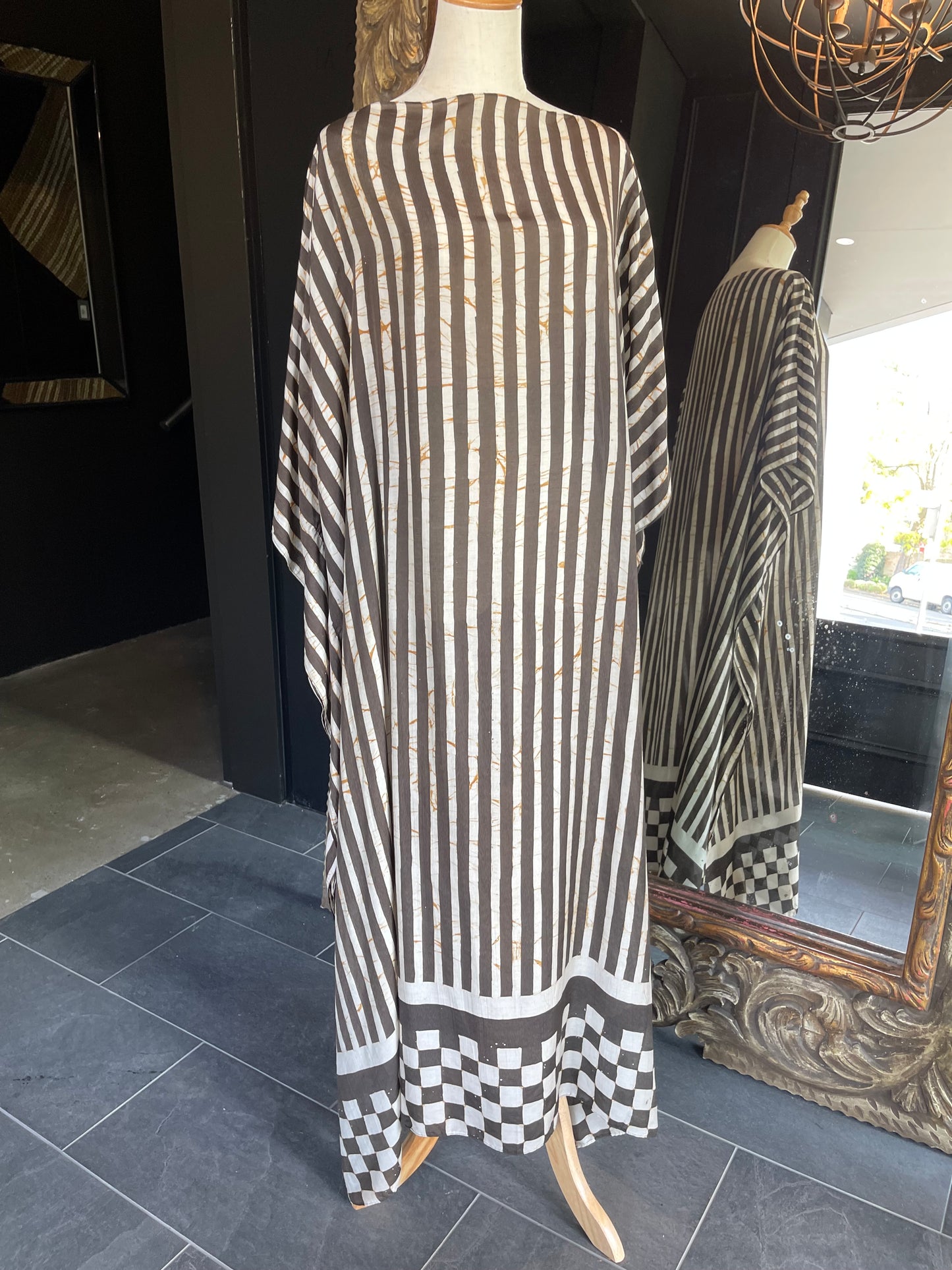 Designed by esteemed Indonesian designer Warwick Purser, this beautiful Kaftan showcases a special pattern printed by hand using the traditional Batik printing methods of East Indonesian villages. Crafted from breathable bamboo, providing lightweight comfort while making it perfect for warmer climates and travelling.