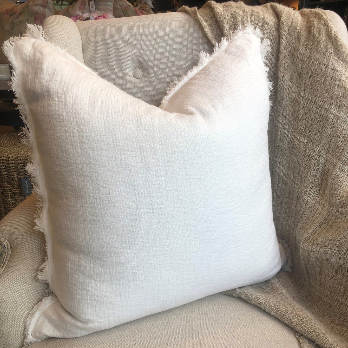 The Anais Pure French Linen Fringed Edge Cushion boasts a custom-woven fabric. It is feather filled for a luxuriously comfortable experience and finished with a charming, rustic egg shell white hue.