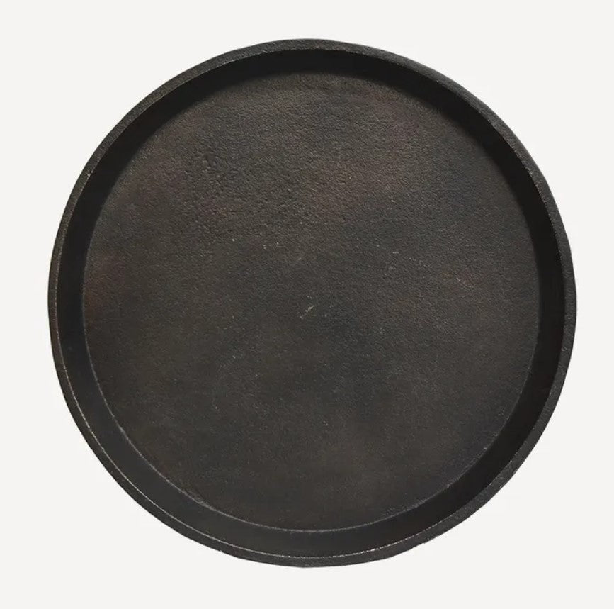 Add a touch of vintage charm to your home decor with the Kara Bronze Round Tray. Its stunning bronze finish and angled lifted edges make it the perfect addition to coffee tables, consoles, or even ottomans. This practical yet elegant accessory will enhance any decorative vignette. front