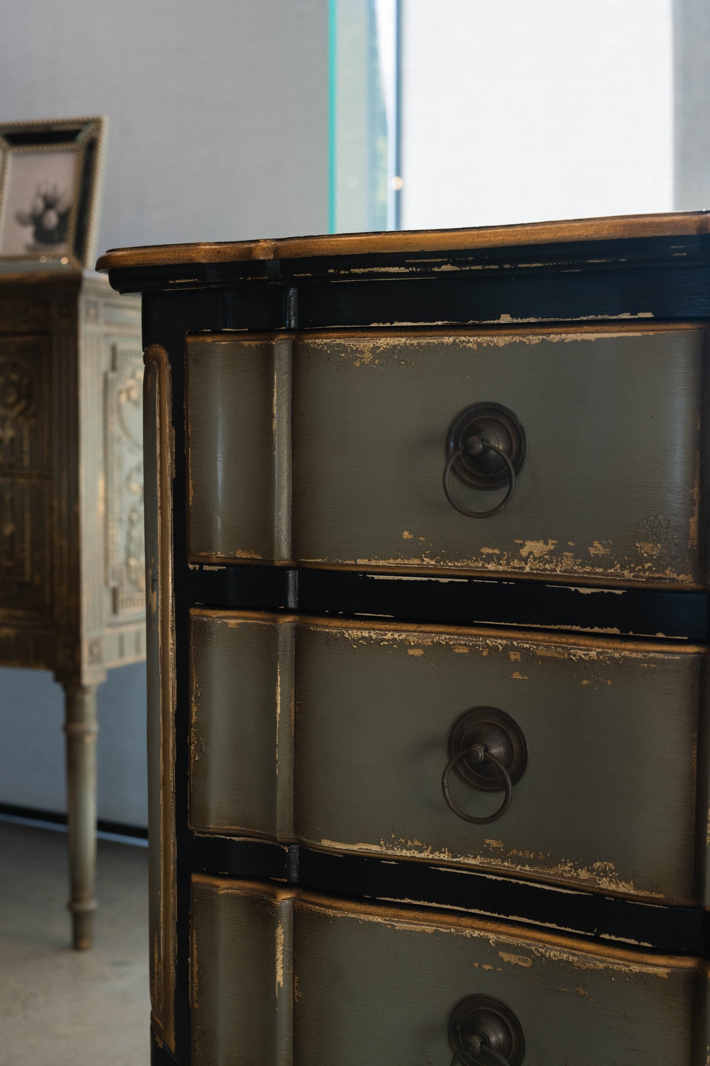The Bellamy Commode is a unique furniture item, expertly crafted from mahogany and boasting a meticulously hand-painted finish. This elegant piece is sure to become a treasured heirloom in any home. Detail