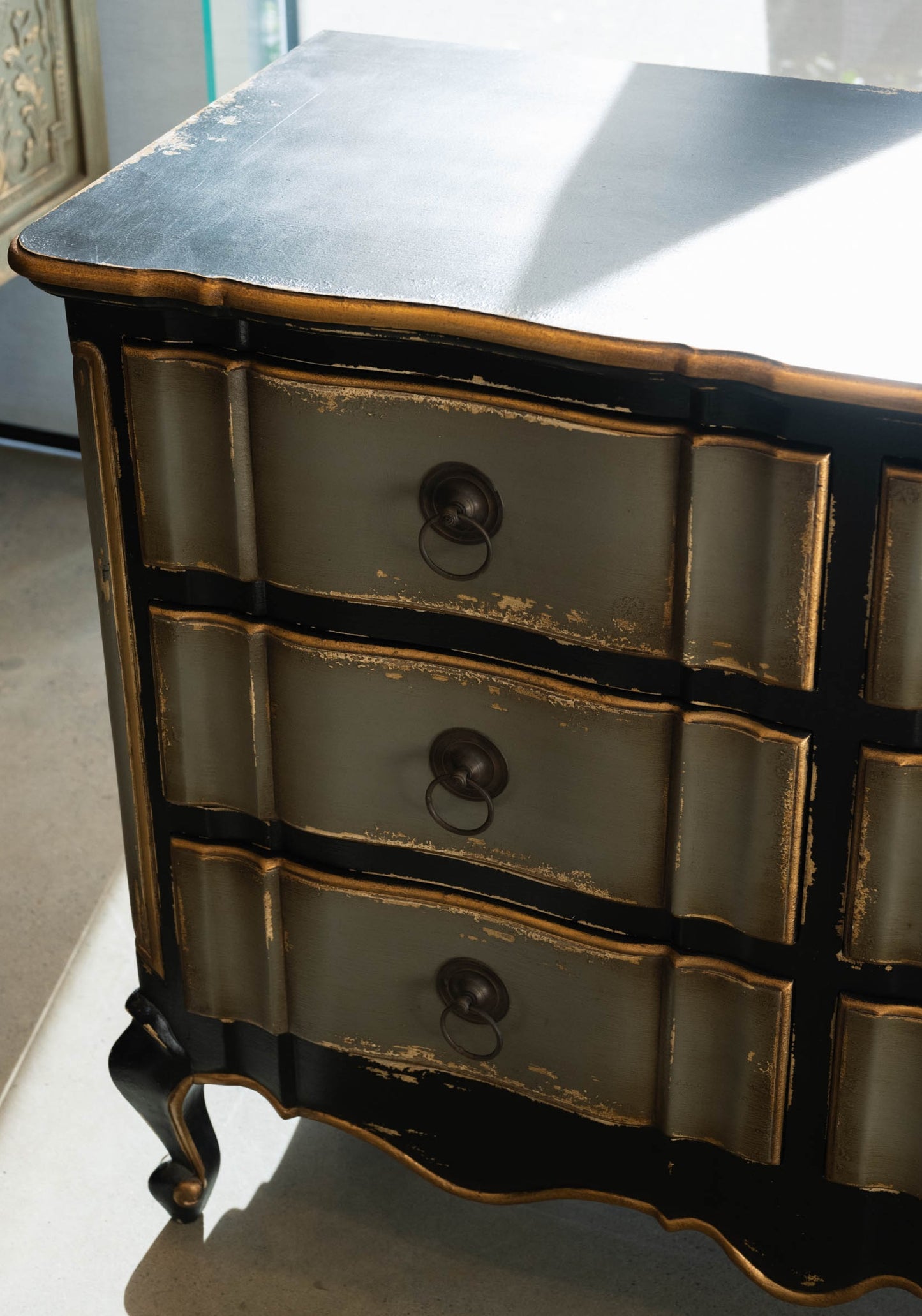 The Bellamy Commode is a unique furniture item, expertly crafted from mahogany and boasting a meticulously hand-painted finish. This elegant piece is sure to become a treasured heirloom in any home. Corner