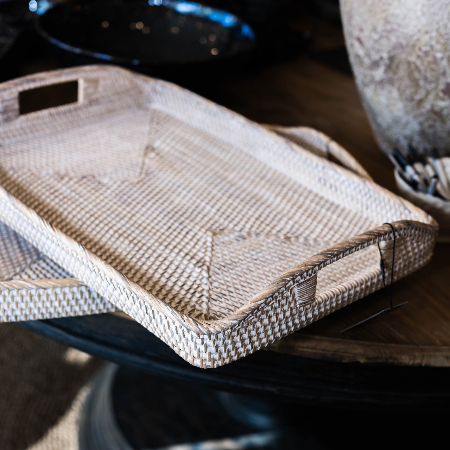 The Handmade Bulan White Washed Rattan Tray was crafted where the history of basket-weaving goes back many centuries. It has a light whitewashed finish that gives off a calm vibe and it can easily transport plates and glasses from the kitchen to the dining table, or it can be placed as decoration on a coffee table or ottoman. Styled.