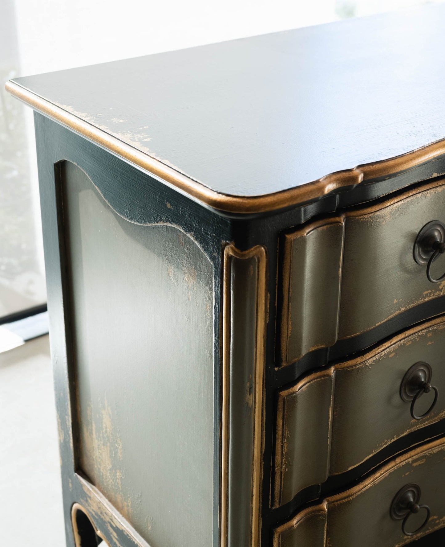 The Bellamy Commode is a unique furniture item, expertly crafted from mahogany and boasting a meticulously hand-painted finish. This elegant piece is sure to become a treasured heirloom in any home. Corner