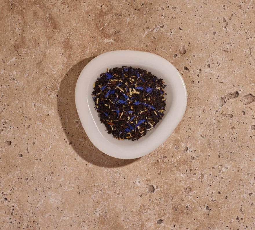 A delicious alluring black tea blend with a nuance of nutty coconut, top note of aromatic peach with slightly spicy and subtle floral overtones of blue cornflowers. Leaving a refreshing and uplifting taste on the palette to awaken your senses, reminiscent of the Australian coast line. Organic Hand blended in Australia Not tested on animals Vegan friendly 200g. Detail
