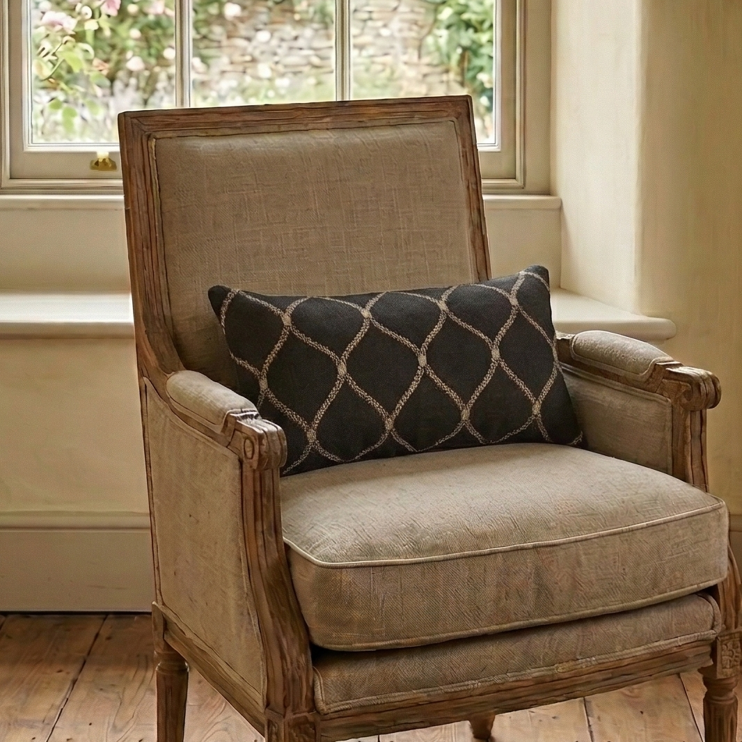 Chair with a cushion in a room with a window and fireplace