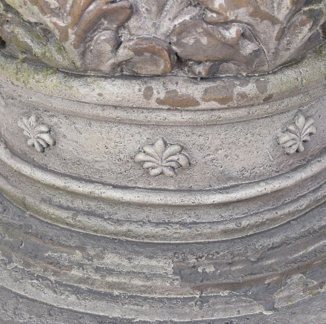 Decorative stone urn with floral patterns and weathered finish