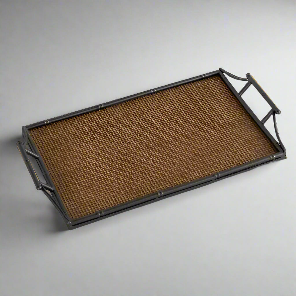 Enhance your home’s style with the Rattan & Faux Bamboo Handle Tray, featuring a textured antique brass finish and comfortable handles for easy carrying. Ideal for showcasing on a coffee table, console, or sideboard, this tray combines distinctive design with practical use. The rattan base paired with faux bamboo metal handles brings a charming, stylish accent to any room.