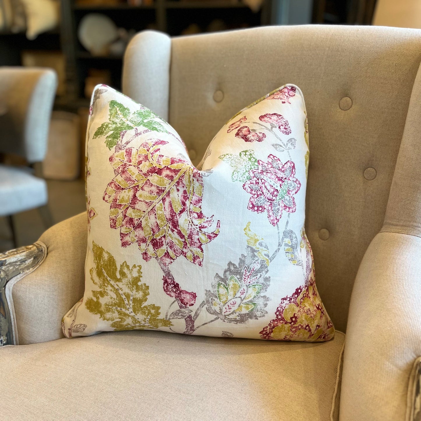 Bring a vibrant burst of color to any space with this beautiful floral print cushion. Featuring shades of raspberry pink, mustard yellow, and green against an ivory background with subtle splashes of grey.
Front Single