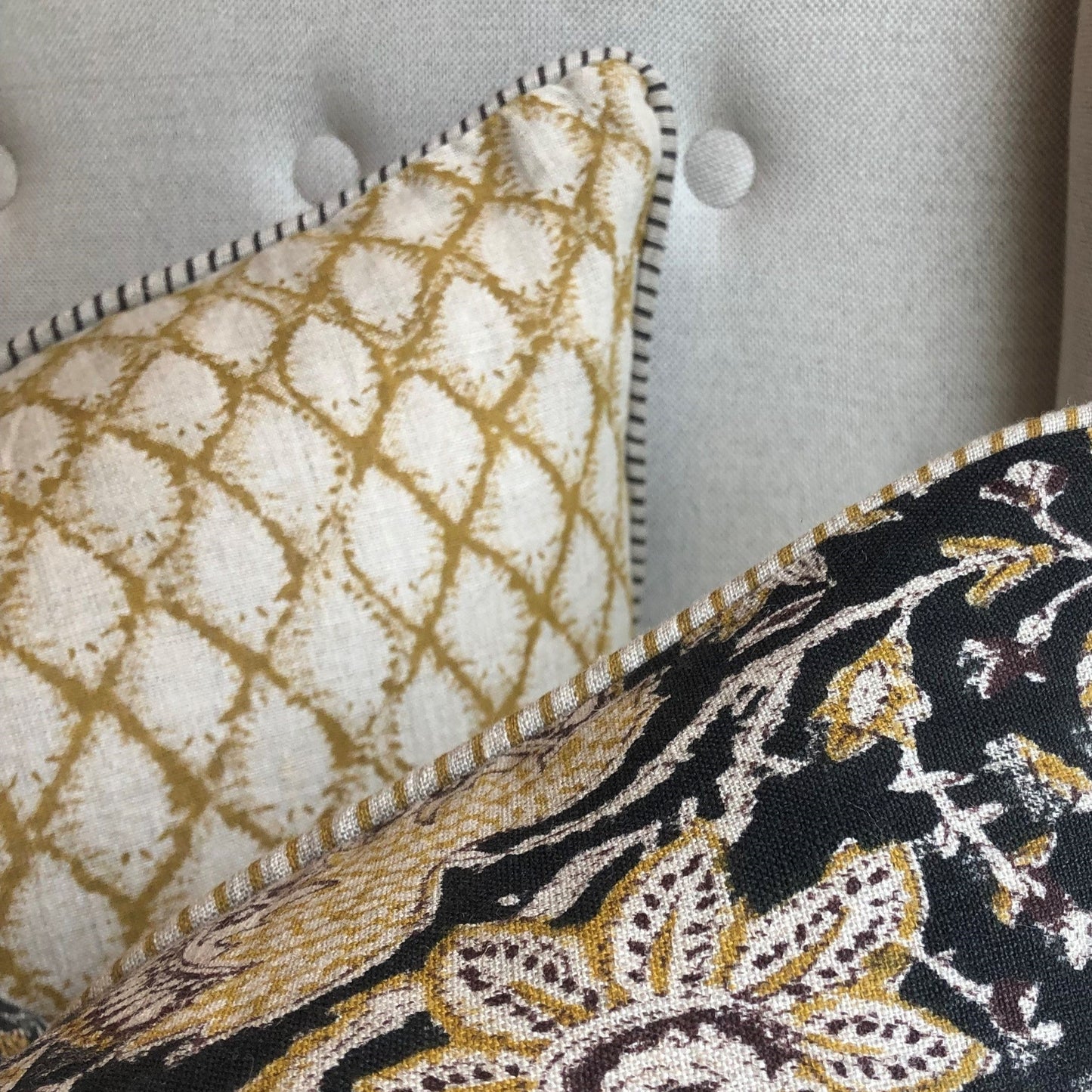 Elevate your home decor with the Cypress Block Printed Linen Ochre Cushion from CHAMOIS, a beloved Swedish brand known for their impeccable style. Crafted from premium Belgian 100% linen and featuring a soft feather insert, this cushion is a must-have for those who appreciate luxurious and high-quality design. Corner detail.