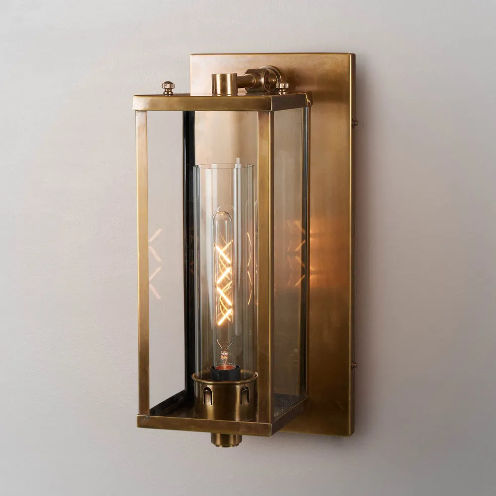 Crafted from brass, the Orleans Wall Sconce provides a warm, inviting atmosphere to any indoor or outdoor space with its aged brass finish and clear glass frame. Its elegant design suits both modern and classic interior/exterior styles and illuminates hallways, entrances and bedrooms. Front