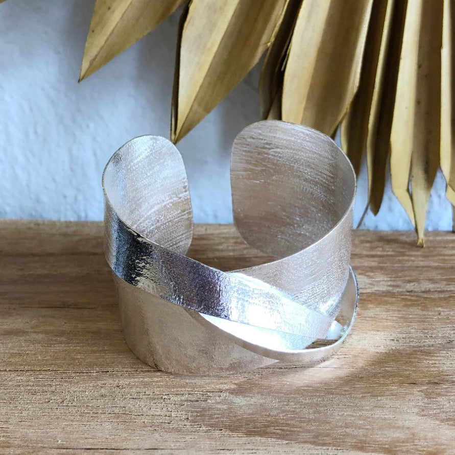 Eris Silver Cuff blends Australian design with Indian craftsmanship, featuring bold architectural lines in brass with refined silver plating. 6cm W x 5cm H.