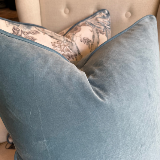 Experience the luxurious softness of our Blue Velvet Cushion. Elevate any space with style and opulence, featuring a hidden zipper for easy use. Filled with feather inserts for ultimate comfort and conveniently machine washable on a delicate cycle. Its stunning colour is perfect for layering with other cushions on a sofa or in the bedroom.