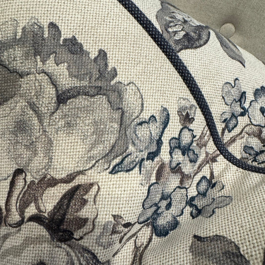 Revitalize your interior with the Warwick Grey Floral Linen & Cotton Cushion, crafted from premium fabric by the distinguished Warwick Fabrics. The exquisite floral pattern in sophisticated grey and taupe tones creates a striking contrast against its neutral base, commanding attention in any room. This sumptuous cushion effortlessly enhances sofas, chairs, or bedding while delivering exceptional comfort with its lavish feather filling. An irresistible statement piece that elevates your home's ambiance