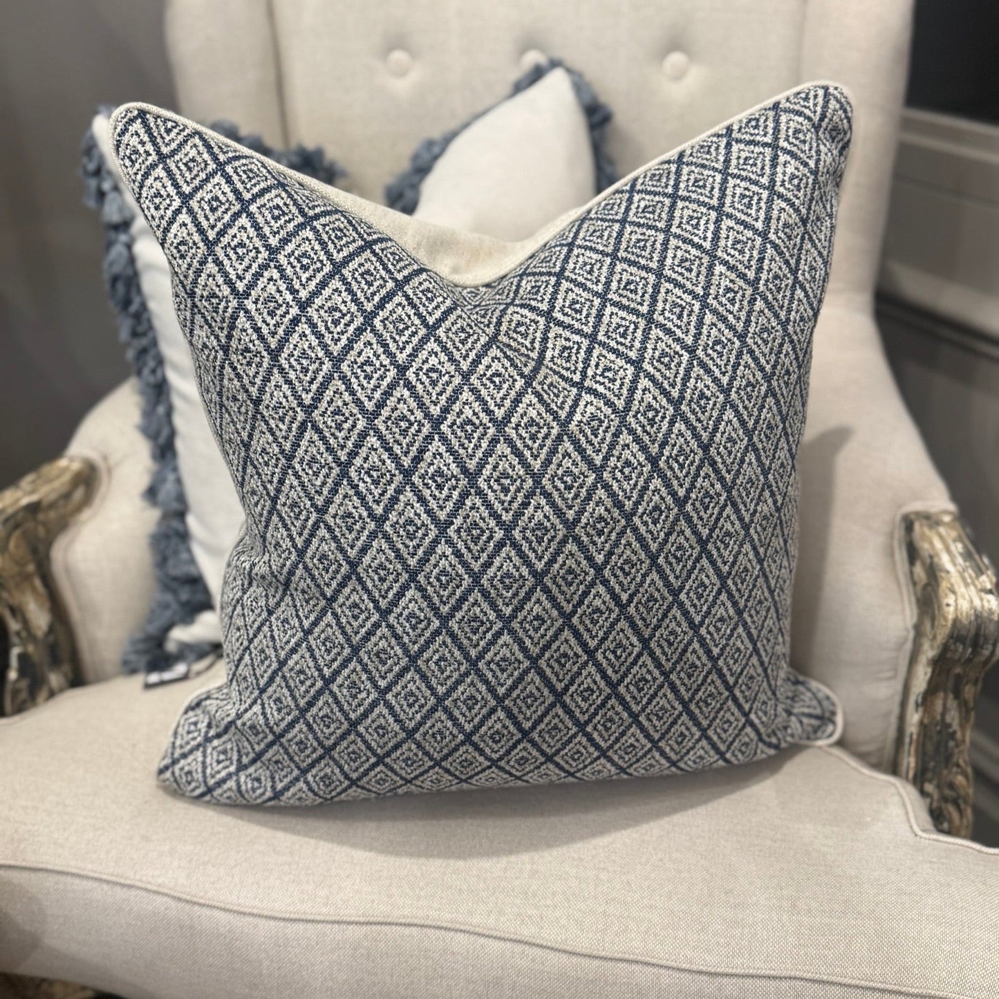 Elevate your home décor with the Hindi Sapphire Cushion crafted from exquisite Slender Morris fabric. Featuring a timeless diamond pattern in soft blue, cream, and taupe tones, it effortlessly complements any cushion arrangement, bringing a refined designer touch to your sofa, chair, or bedroom. Filled with luxurious feathers, it offers exceptional comfort, while the natural self-piping adds a polished, sophisticated finish. The plain natural back enhances its classic appeal, making it a perfect addition to