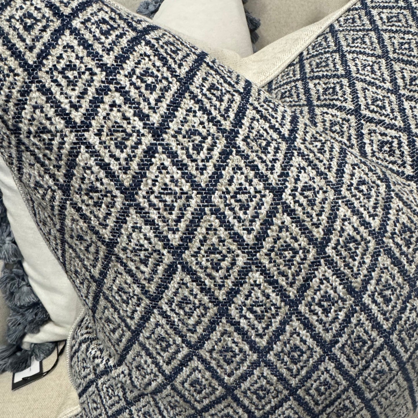 Elevate your home décor with the Hindi Sapphire Cushion crafted from exquisite Slender Morris fabric. Featuring a timeless diamond pattern in soft blue, cream, and taupe tones, it effortlessly complements any cushion arrangement, bringing a refined designer touch to your sofa, chair, or bedroom. Filled with luxurious feathers, it offers exceptional comfort, while the natural self-piping adds a polished, sophisticated finish. The plain natural back enhances its classic appeal, making it a perfect addition to