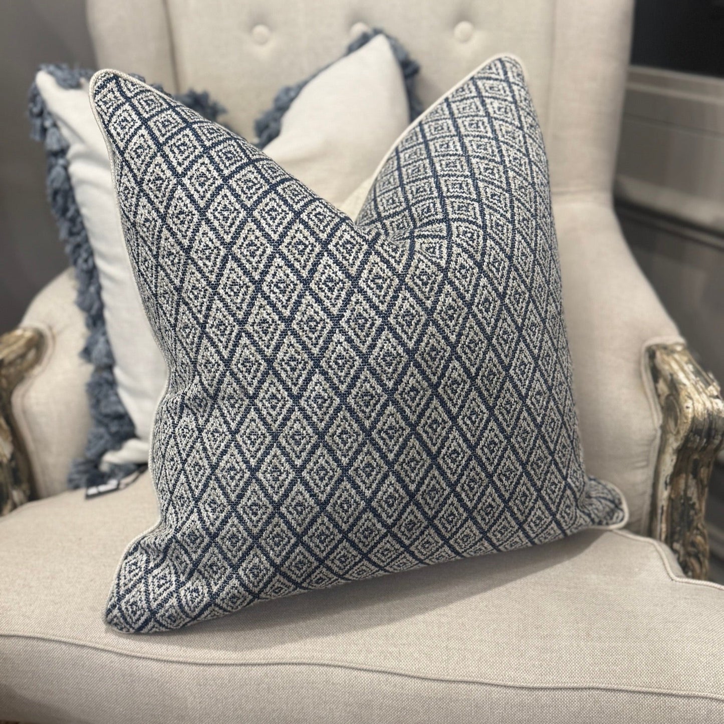 Elevate your home décor with the Hindi Sapphire Cushion crafted from exquisite Slender Morris fabric. Featuring a timeless diamond pattern in soft blue, cream, and taupe tones, it effortlessly complements any cushion arrangement, bringing a refined designer touch to your sofa, chair, or bedroom. Filled with luxurious feathers, it offers exceptional comfort, while the natural self-piping adds a polished, sophisticated finish. The plain natural back enhances its classic appeal, making it a perfect addition to