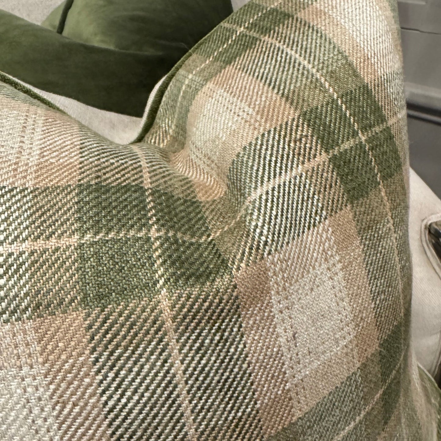 The Green & Ivory Check Cushion combines a high-quality cotton and linen blend with a stylish check design and a neutral reverse crafted from Warwick Fabrics Haven fabric. Accented with green velvet piping, this cushion adds a polished, designer look to your sofa, chair, or bedroom. Its plush feather filling ensures both comfort and elegance in your living space.