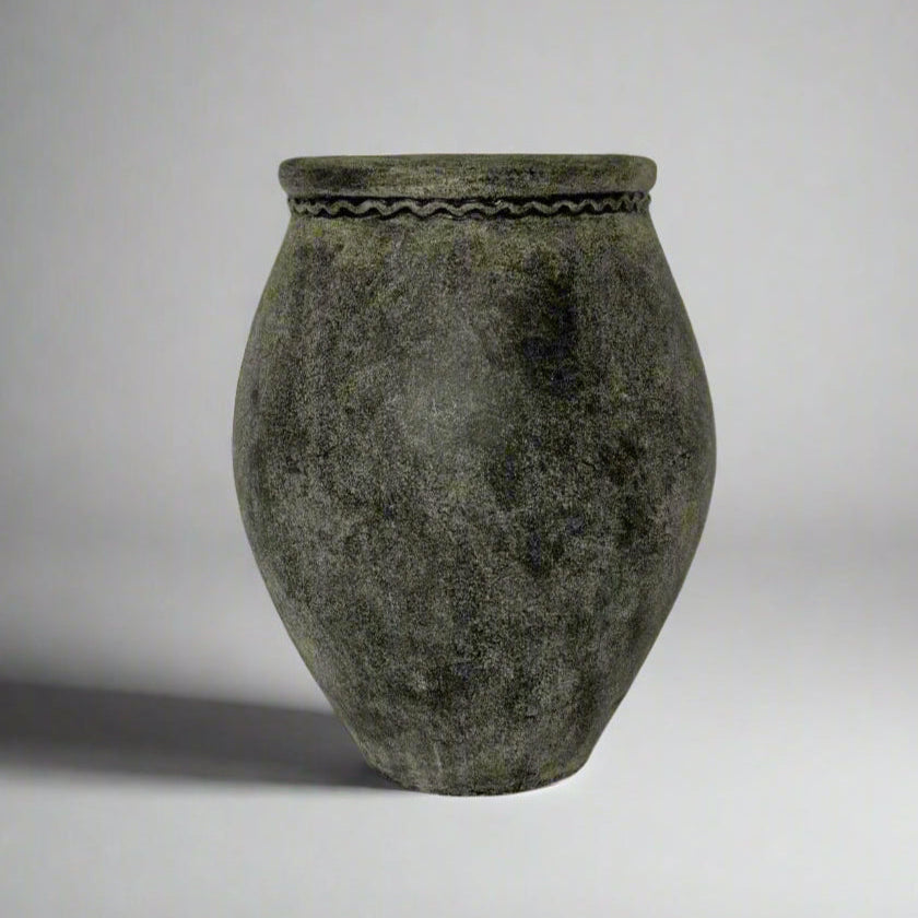 Textured gray pot on a light gray background