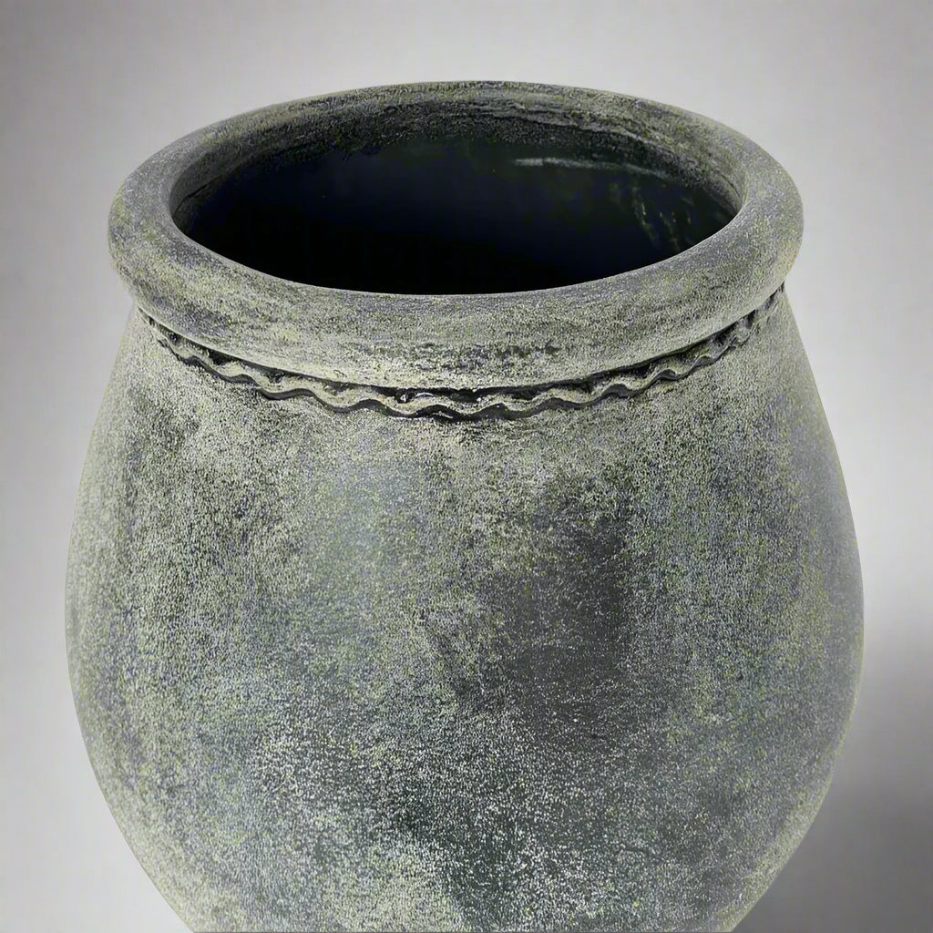 Textured gray pot on a light gray background