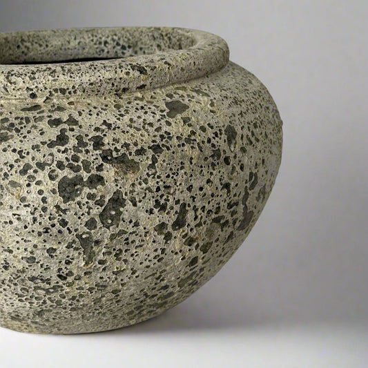 Textured stone-like object on a light gray background