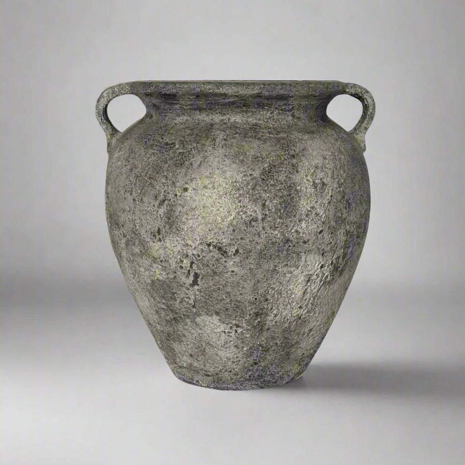 Ancient terracotta jar with two handles on a gray background