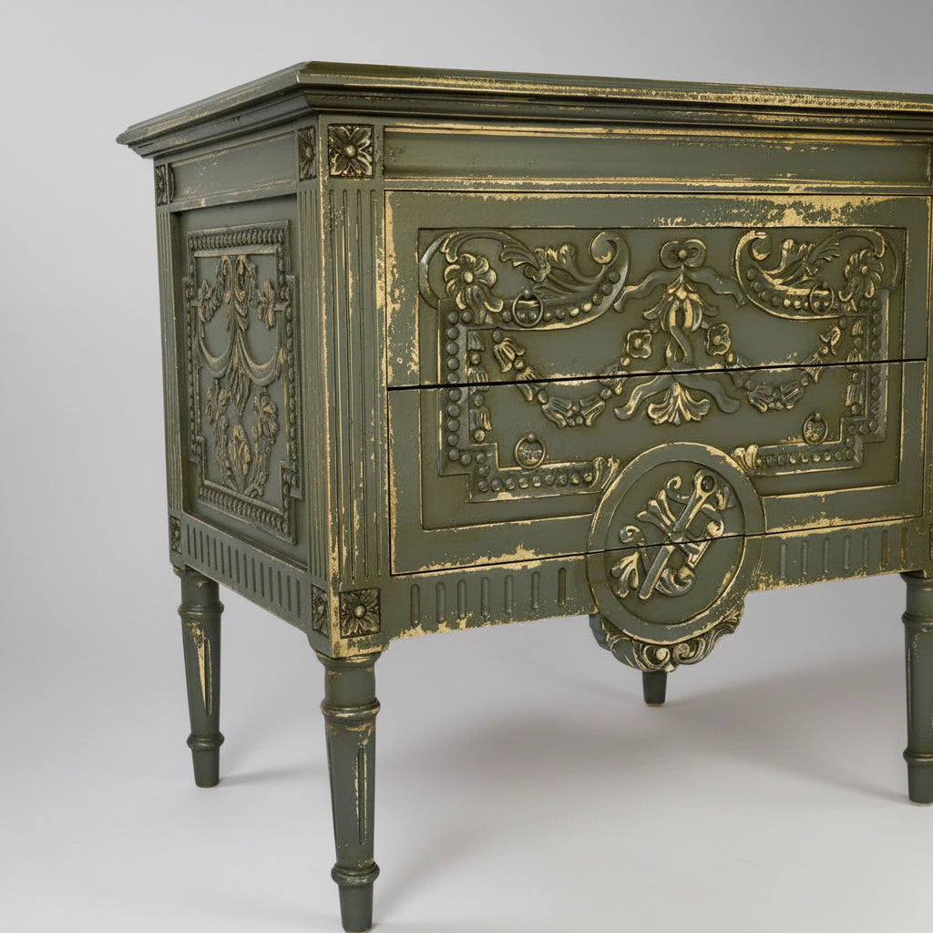 Decorative chest of drawers with gold accents on a white background