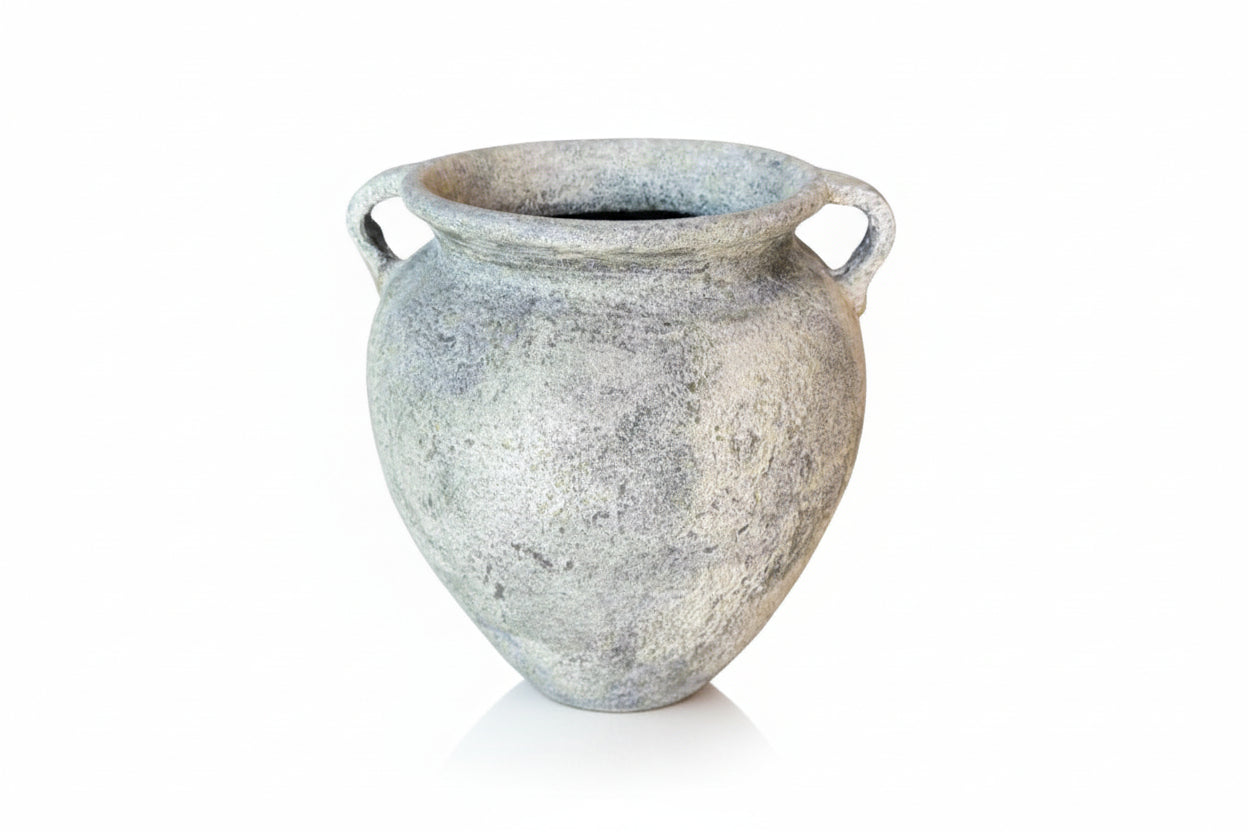 Vintage-style ceramic vase with textured surface on a gray background