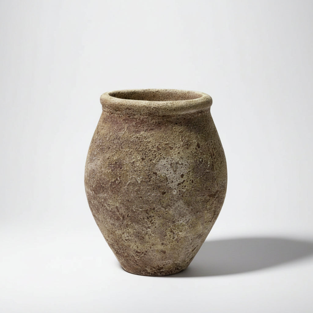 Textured ceramic vase on a light gray background