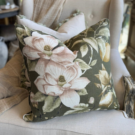 Floral patterned pillow on a beige armchair