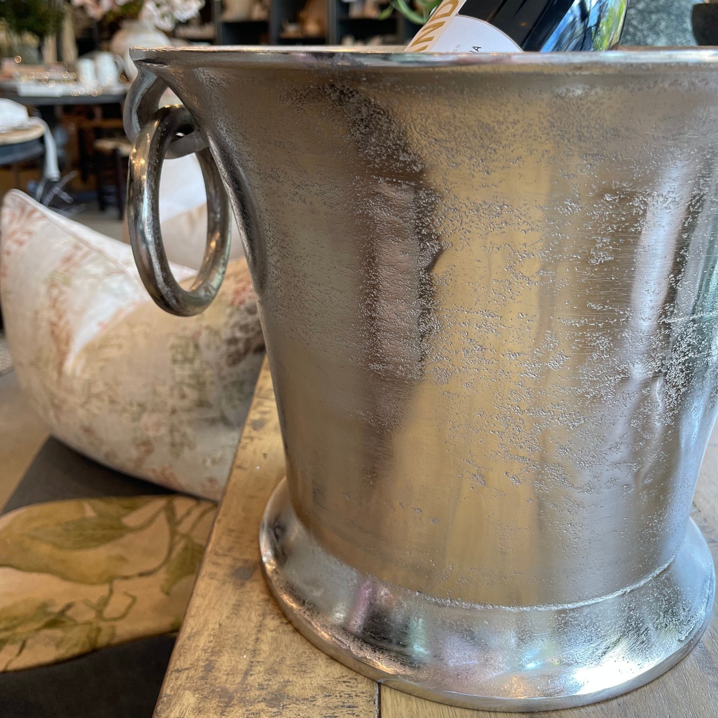 Indulge in the luxurious experience of using our Champagne Bucket with Ring Handles. Impress your guests and keep your drinks chilled with this elegant addition to your entertaining essentials. Elevate any special occasion with this stunning table feature. Close up.