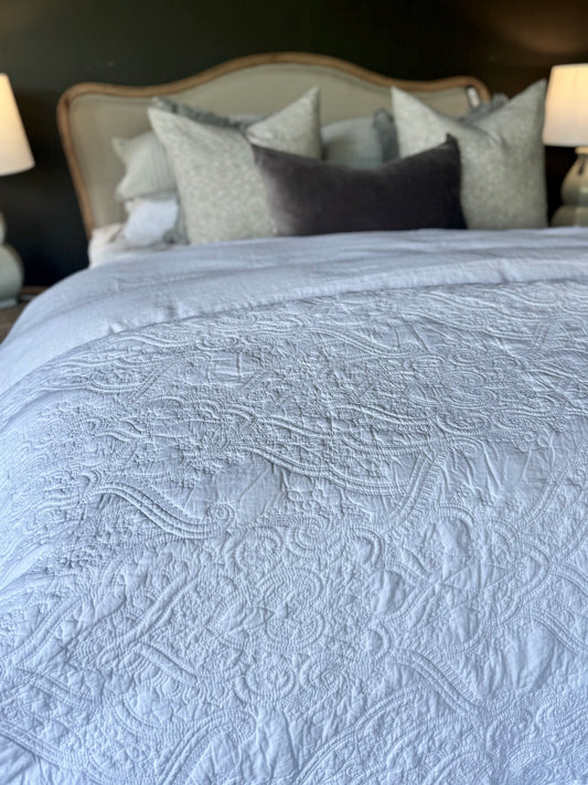 This Provence Damask 100% cotton quilt exudes both comfort and style. Featuring a charming and timeless pattern with intricate cross stitching, it's sure to add a touch of elegance to your bedroom. Crafted with soft and luxurious 100% cotton fabric and wadding, it's also conveniently machine washable on a delicate cycle. Styled close up.