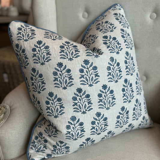 Indulge in the impeccable artistry of this high-quality Amer Azur Oatmeal Navy Floral Linen Cushion. Created by luxury textile house Walter G. and fashioned with dense, 100% linen material, it boasts a stunning navy and light blue floral pattern against an oatmeal backdrop. Complete with a feather insert for ultimate comfort. Reverse lined with oatmeal linen. Side.