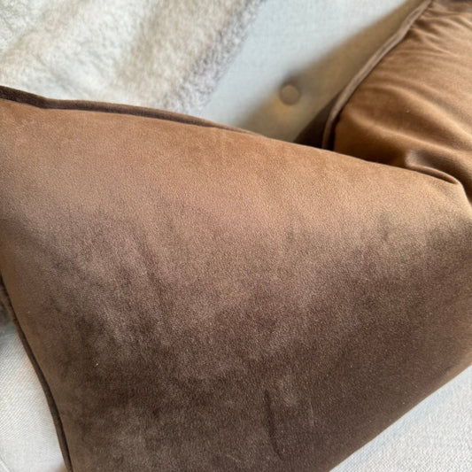 Indulge in the opulent comfort of the Coco Velvet Lumbar Cushion. This superb cushion enhances any room with its sophisticated design and features a discreet zipper for easy handling. Filled with feather inserts for unparalleled coziness and conveniently machine washable on a delicate cycle. The warm honeycomb colour exudes an air of refinement and complements a range of hues. The sumptuous velvet fabric is accented with thick matching piping on all sides.