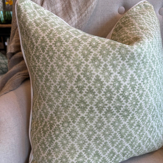 Add sophistication to your space with Amelie Green Cushion. The intricate green pattern on an ivory backdrop creates an elegant look. The reverse side showcases ivory and the cushion is completed with ivory self-piping. Additionally, the feather insert ensures maximum comfort.