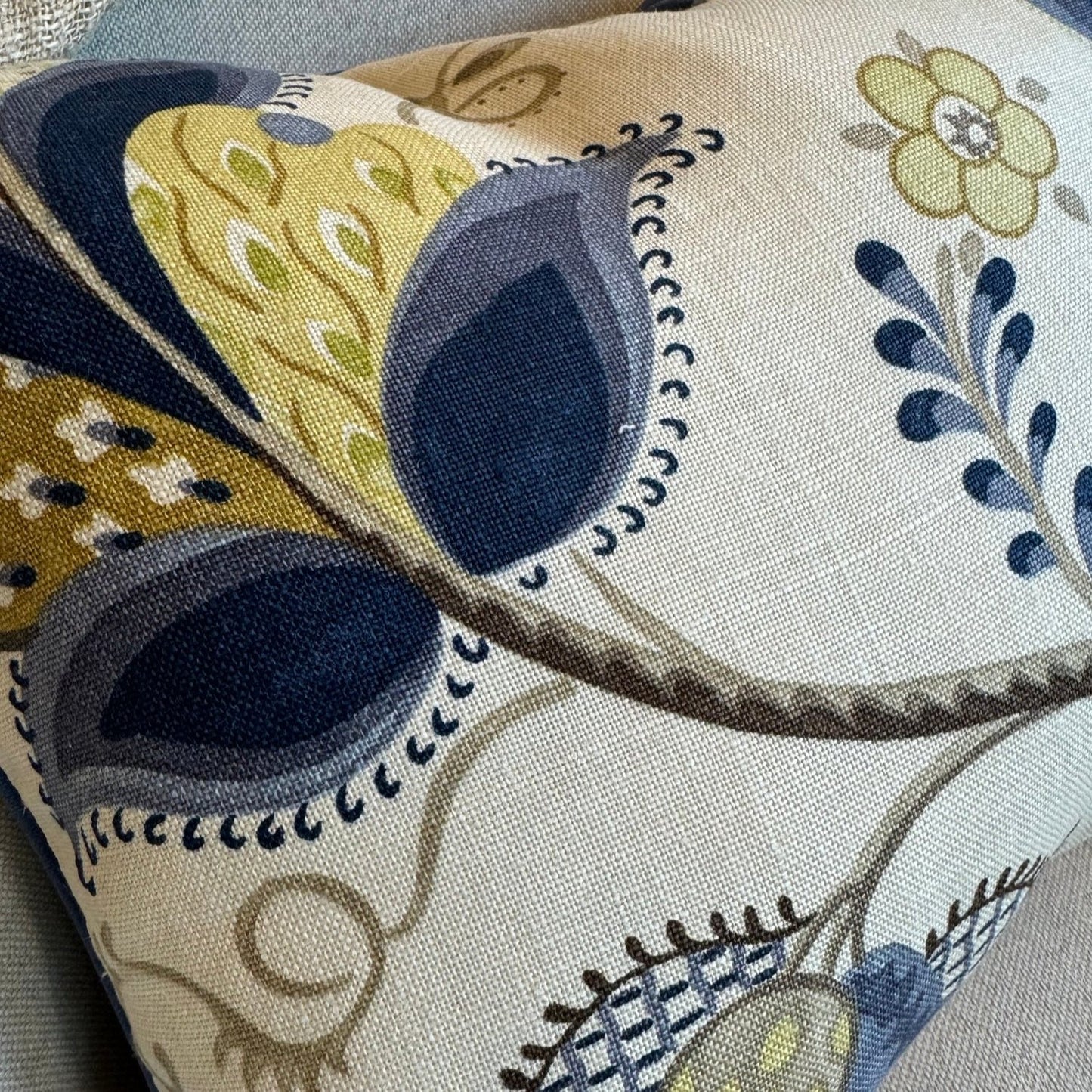 Indulge in the exquisite texture of the meticulously made Sophia Floral Heavyweight Cushion. This cushion boasts a stunning blue and green floral pattern on a neutral backdrop, and includes a plush feather insert for unparalleled coziness. The back is enhanced with oatmeal linen for a sophisticated touch.