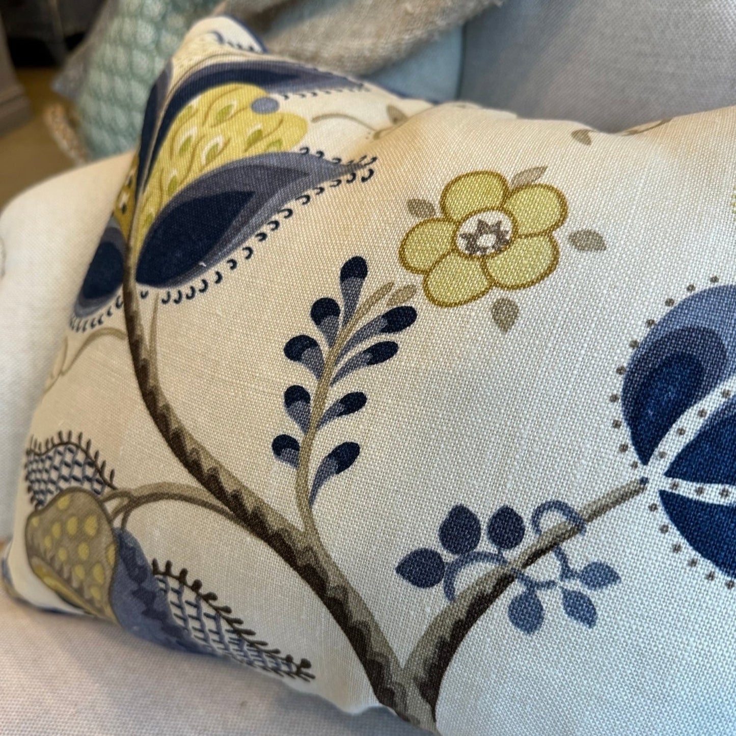 Indulge in the exquisite texture of the meticulously made Sophia Floral Heavyweight Cushion. This cushion boasts a stunning blue and green floral pattern on a neutral backdrop, and includes a plush feather insert for unparalleled coziness. The back is enhanced with oatmeal linen for a sophisticated touch.