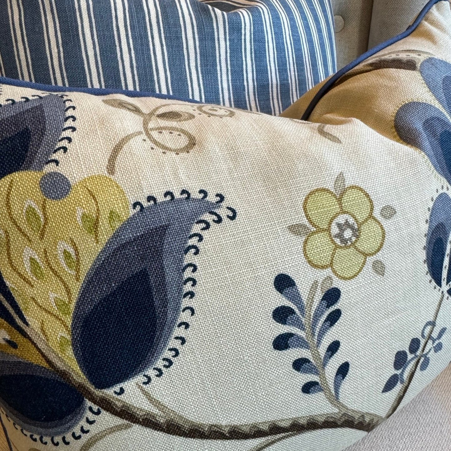 Indulge in the exquisite texture of the meticulously made Sophia Floral Heavyweight Cushion. This cushion boasts a stunning blue and green floral pattern on a neutral backdrop, and includes a plush feather insert for unparalleled coziness. The back is enhanced with oatmeal linen for a sophisticated touch.