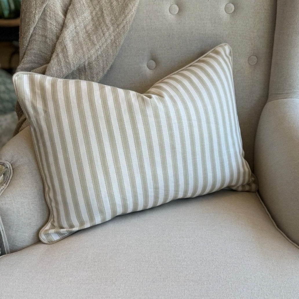 Indulge in the luxurious feel of our Striped Pale Olive & Ivory Lumbar Cushion crafted from a sumptuous heavyweight fabric. The pale olive stripe against ivory background exudes timeless elegance and grace, making it the perfect addition to any sophisticated home decor. Comes with a luxurious feather insert for added comfort.