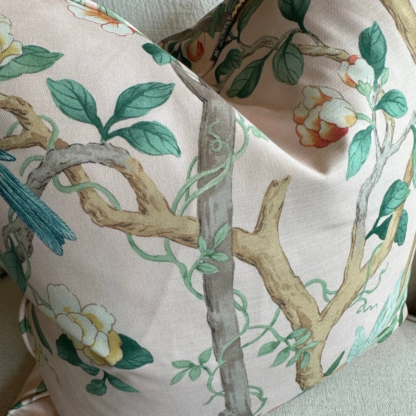 Experience the beauty of nature with this vibrant apricot pink cotton cushion, featuring charming birds, delicate butterflies, and lush botanicals. Add a pop of color to any space and elevate your home decor with this lovely accent cushion, complete with a soft duck feather insert.