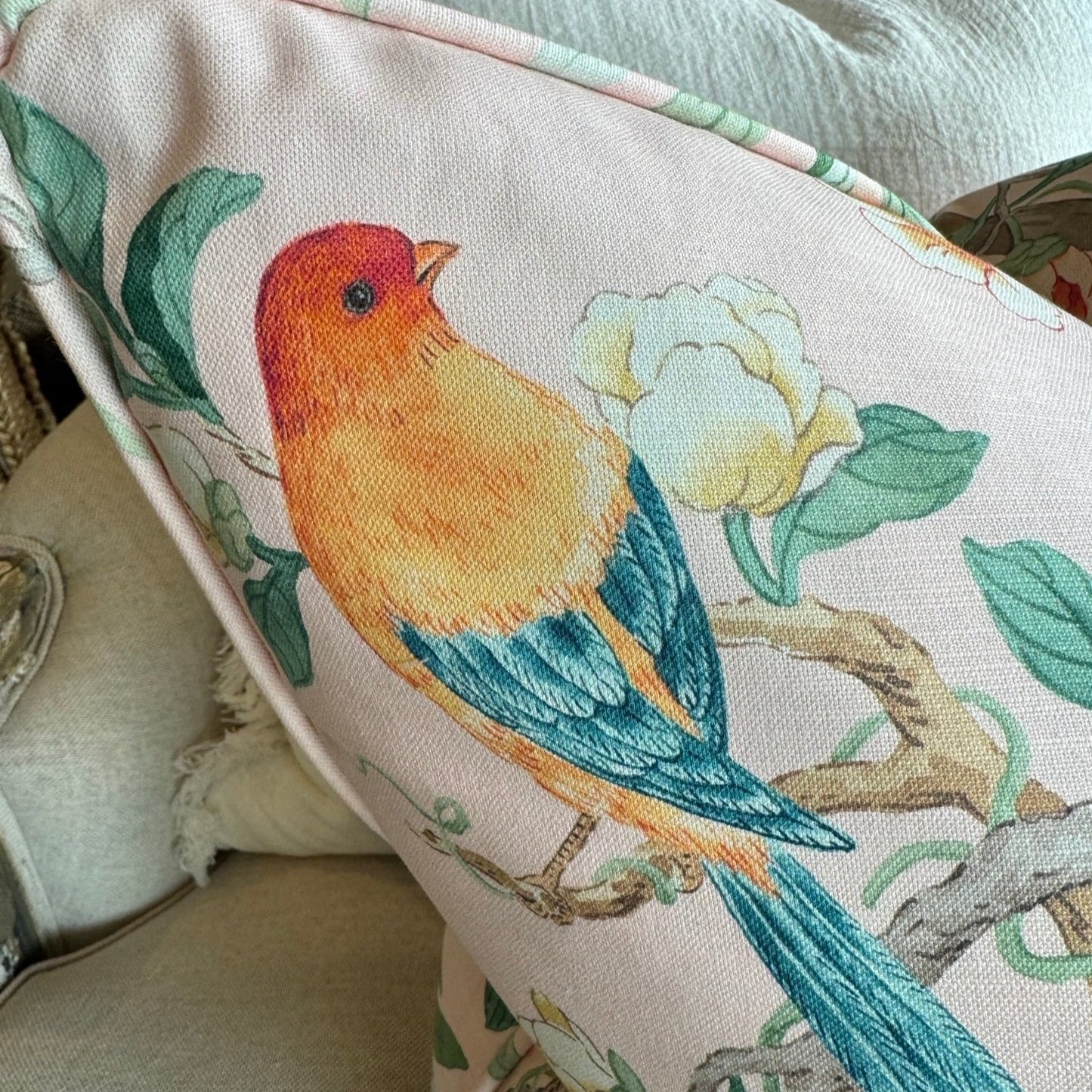 Experience the beauty of nature with this vibrant apricot pink cotton cushion, featuring charming birds, delicate butterflies, and lush botanicals. Add a pop of color to any space and elevate your home decor with this lovely accent cushion, complete with a soft duck feather insert.