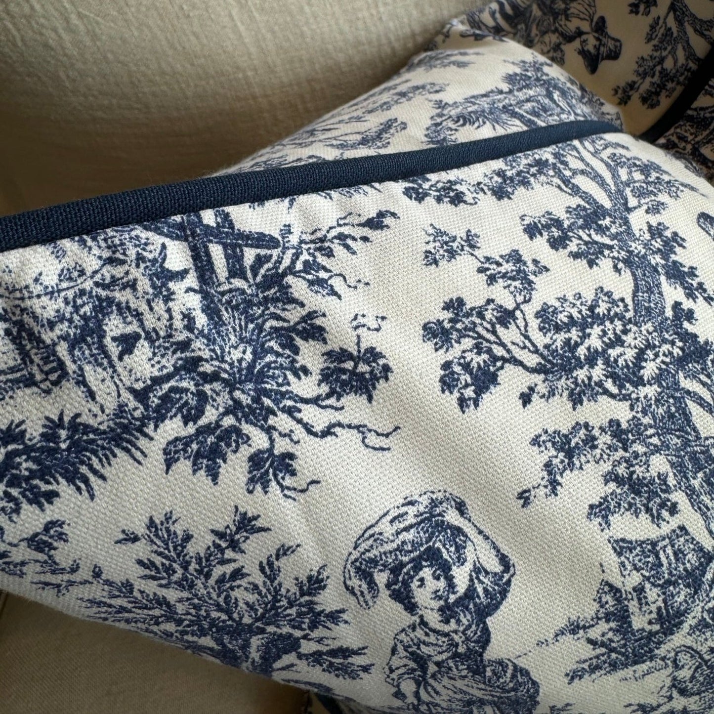 Elevate your living space with the timeless elegance of this classic blue and white toile cushion. The delicate vintage print adds a touch of sophistication, while the bold white background creates a striking contrast. And with its plush duck feather insert, it's the perfect accent piece to add comfort and style to any room.