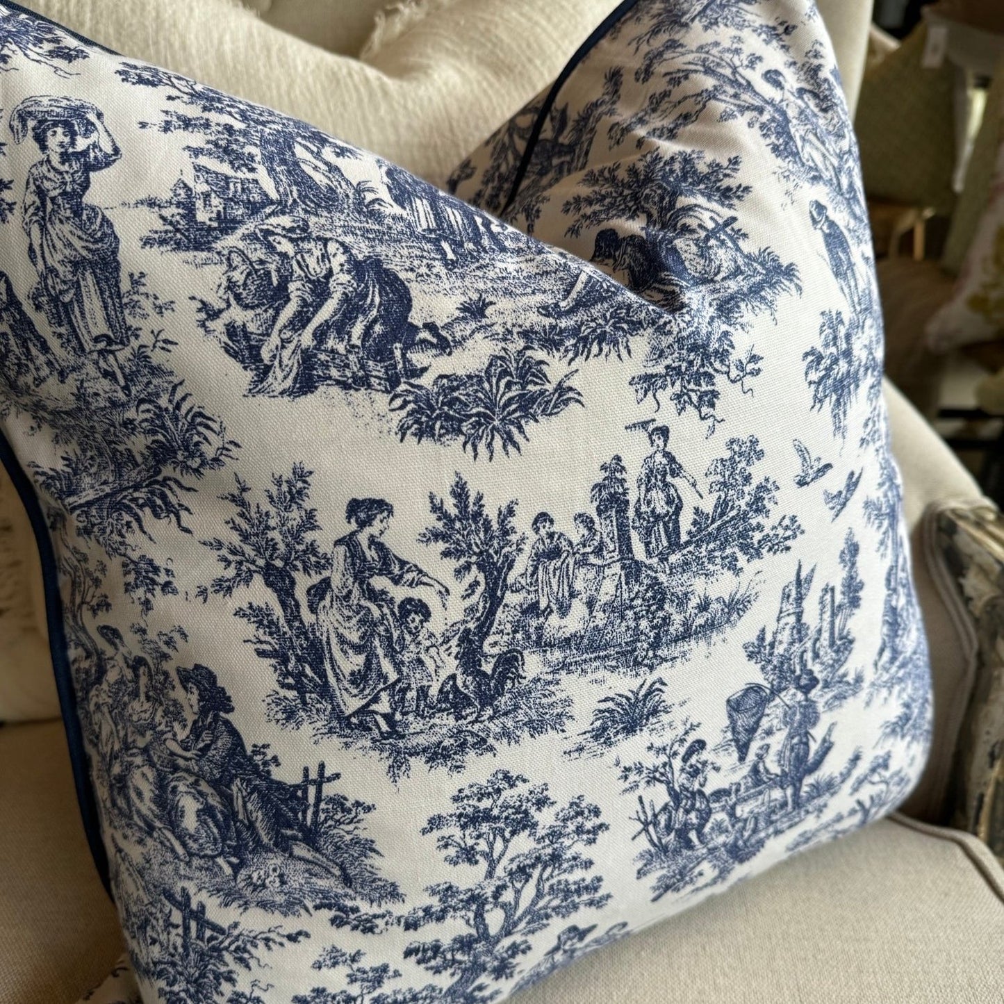 Elevate your living space with the timeless elegance of this classic blue and white toile cushion. The delicate vintage print adds a touch of sophistication, while the bold white background creates a striking contrast. And with its plush duck feather insert, it's the perfect accent piece to add comfort and style to any room.