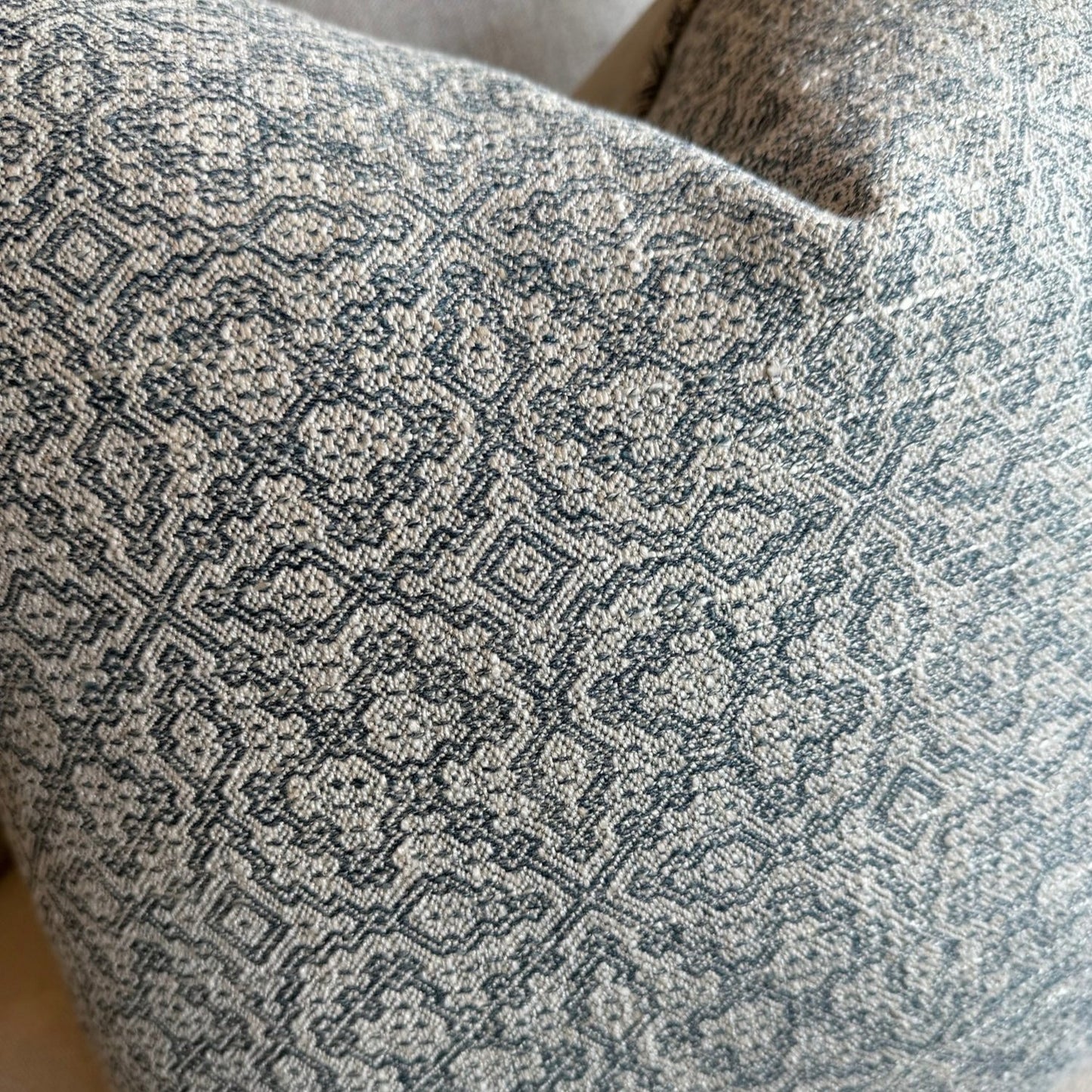 The Lilibet Woven Linen Cushion features a beautiful mixture of dove grey and navy blue patterns, making it a visually stunning addition to any living space. The luxurious feather insert adds an indulgent touch, perfect for those seeking to elevate their home decor. With a subtle pattern, it creates an inviting atmosphere that is both elegant and inviting.