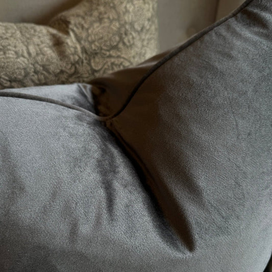 Experience the luxurious softness of our Dark Grey Velvet Cushion. This stylish and elegant cushion features a concealed zipper for effortless use and is filled with feather inserts for ultimate comfort. It is also machine washable on a delicate cycle, making it perfect for adding style and comfort to any bed or sofa.