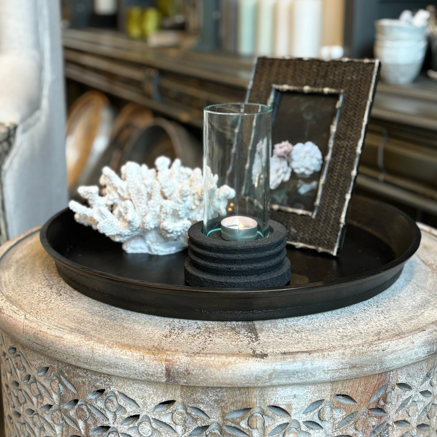 Add a touch of vintage charm to your home decor with the Kara Bronze Round Tray. Its stunning bronze finish and angled lifted edges make it the perfect addition to coffee tables, consoles, or even ottomans. This practical yet elegant accessory will enhance any decorative vignette. front