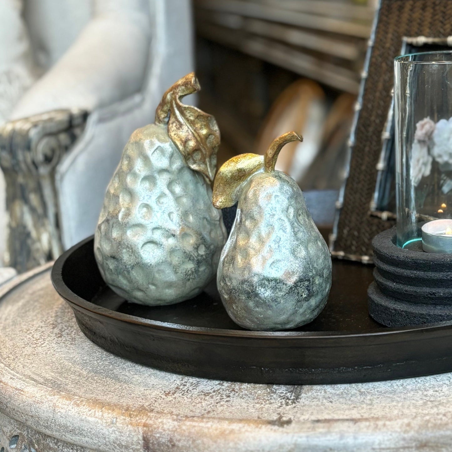 Elevate your decor with our Antiqued Silver & Gold Pear Ornament - a perfect addition to any space. Crafted with resin, it features an antiqued silver finish and delicate detailing of gold stem and leaves. Use it on coffee tables, shelves, or consoles to bring a touch of opulence and sophistication to your home.