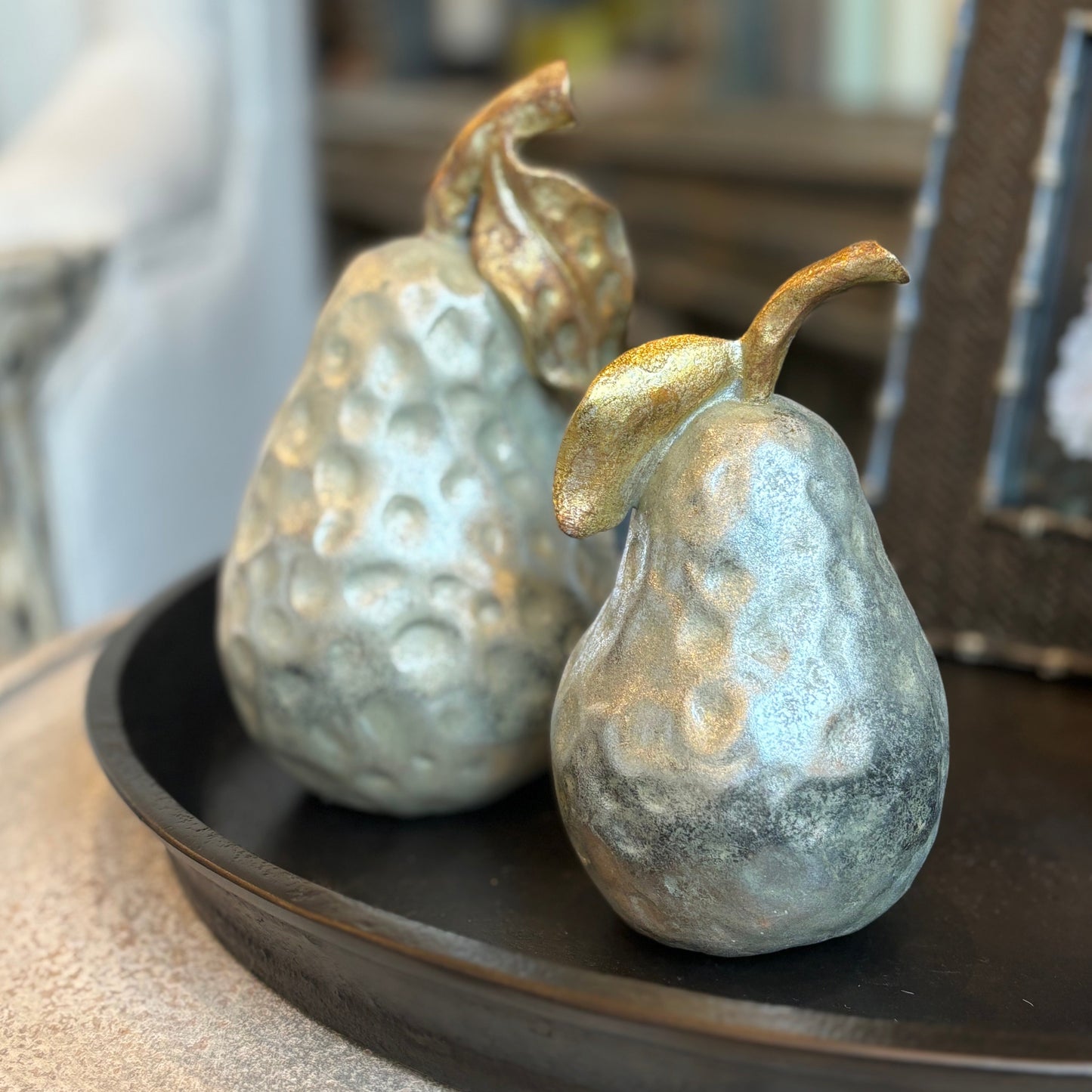 Elevate your decor with our Antiqued Silver & Gold Pear Ornament - a perfect addition to any space. Crafted with resin, it features an antiqued silver finish and delicate detailing of gold stem and leaves. Use it on coffee tables, shelves, or consoles to bring a touch of opulence and sophistication to your home.