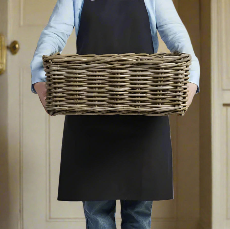 Experience the perfect blend of functionality and design with this versatile classic rattan rectangular basket. Its low, straight sides and strong integrated handles make it both strong and practical. 